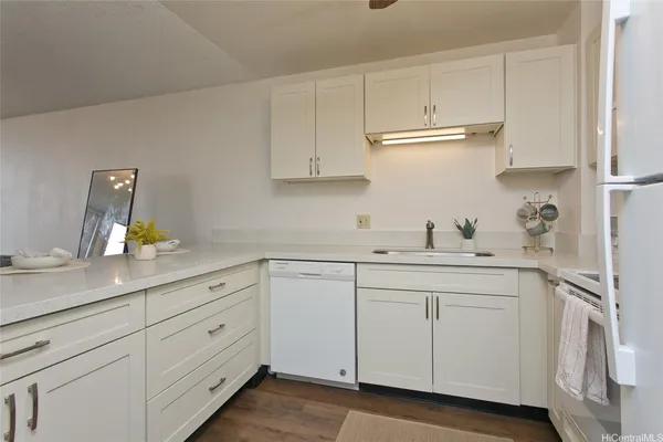 a kitchen with white cabinets and white appliances