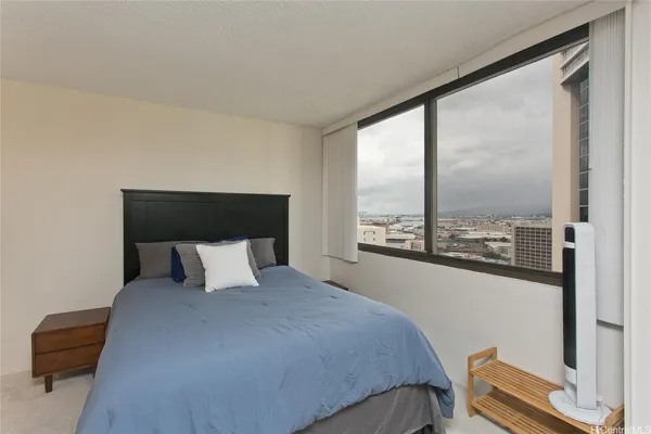 a bedroom with a large bed and a window