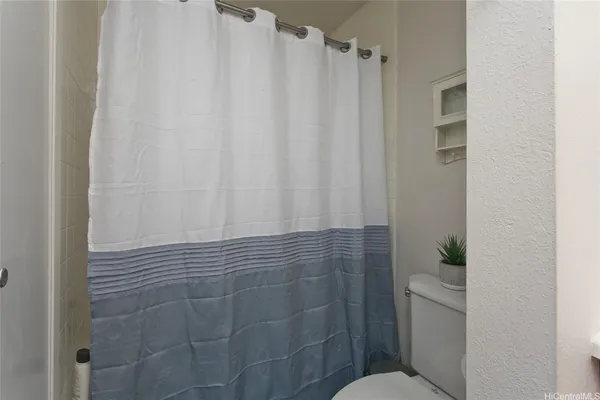 a bathroom with a shower curtain and sink