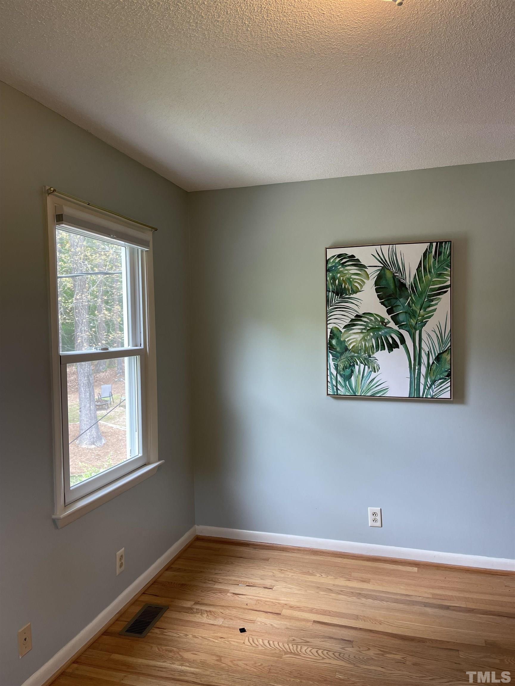 3213 Broyhill Circle Raleigh, NC 27604 - Photo 11 of 15 an empty room with wooden floor and window