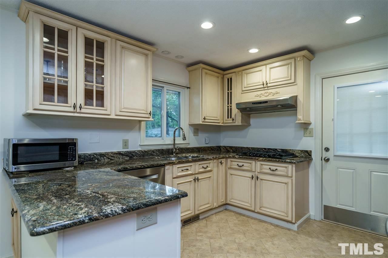 3213 Broyhill Circle Raleigh, NC 27604 - Photo 4 of 15 a kitchen with stainless steel appliances granite countertop a sink and cabinets