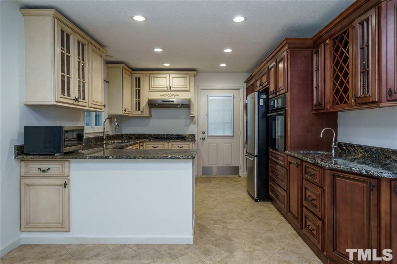 3213 Broyhill Circle Raleigh, NC 27604 - Photo 6 of 15 a kitchen with stainless steel appliances granite countertop a refrigerator a stove and a sink