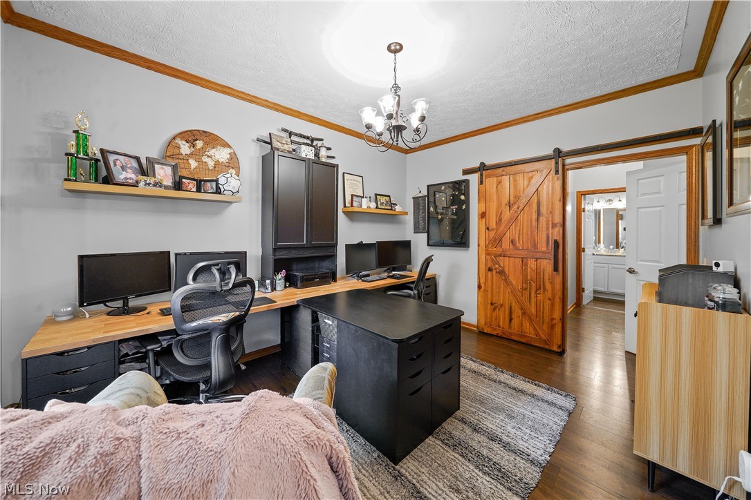 4849 Edson Road Kent, OH 44240 - Photo 24 of 50 Office space featuring crown molding, dark hardwood / wood-style floors, a barn door, a notable chandelier, and a textured ceiling