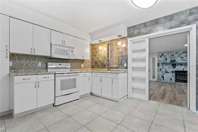 a view of empty room with fireplace and wooden floor