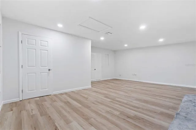 a view of wooden floor with a fireplace in a room