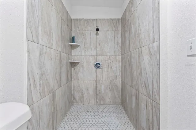 a white house that has a tree in front of it