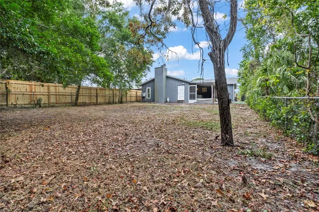 a front view of a house with a tree