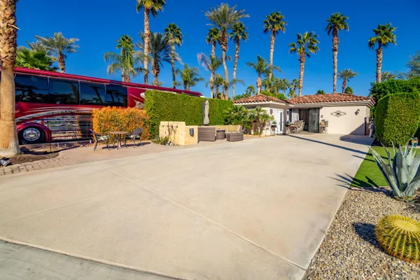 a view of a street with potted plants