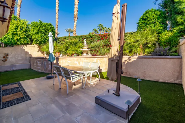 a view of a backyard with sitting area