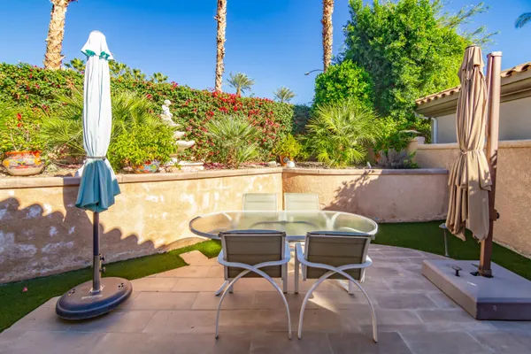 a view of a patio with table and chairs and potted plants
