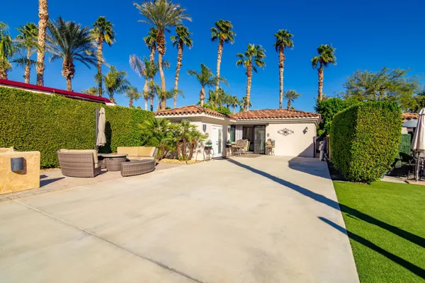 a view of a patio with a table and chairs