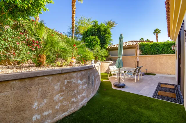 a view of a chairs and table in patio