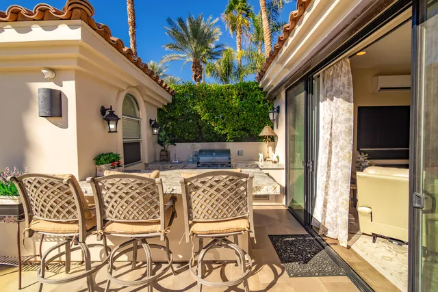 a view of a patio with table and chairs and potted plants