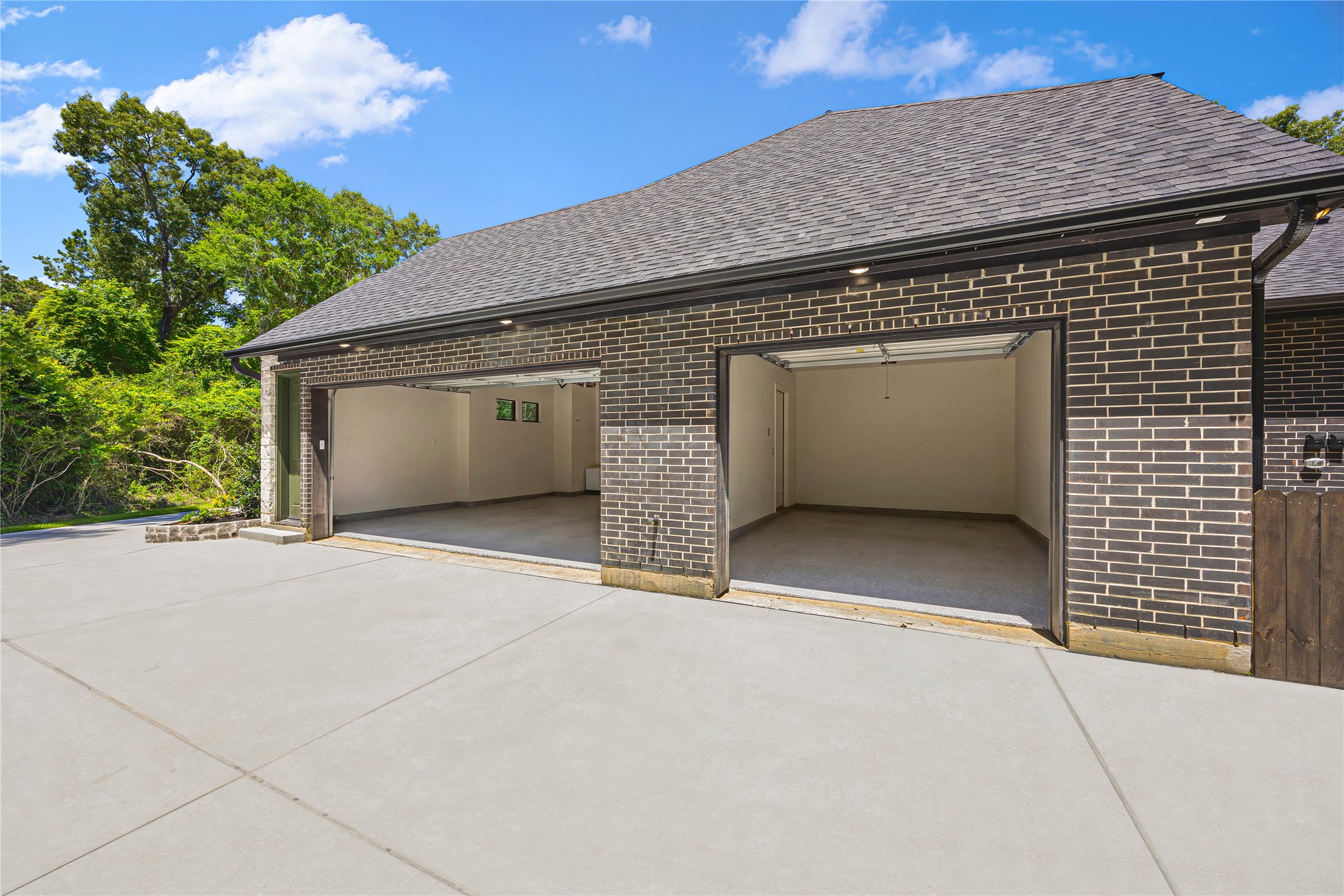 19314 Chateau Ridge Court Tomball, TX 77377 - Photo 45 of 50 Spacious 3-car garage featuring professionally finished epoxy flooring for a clean, durable, and high-end look.