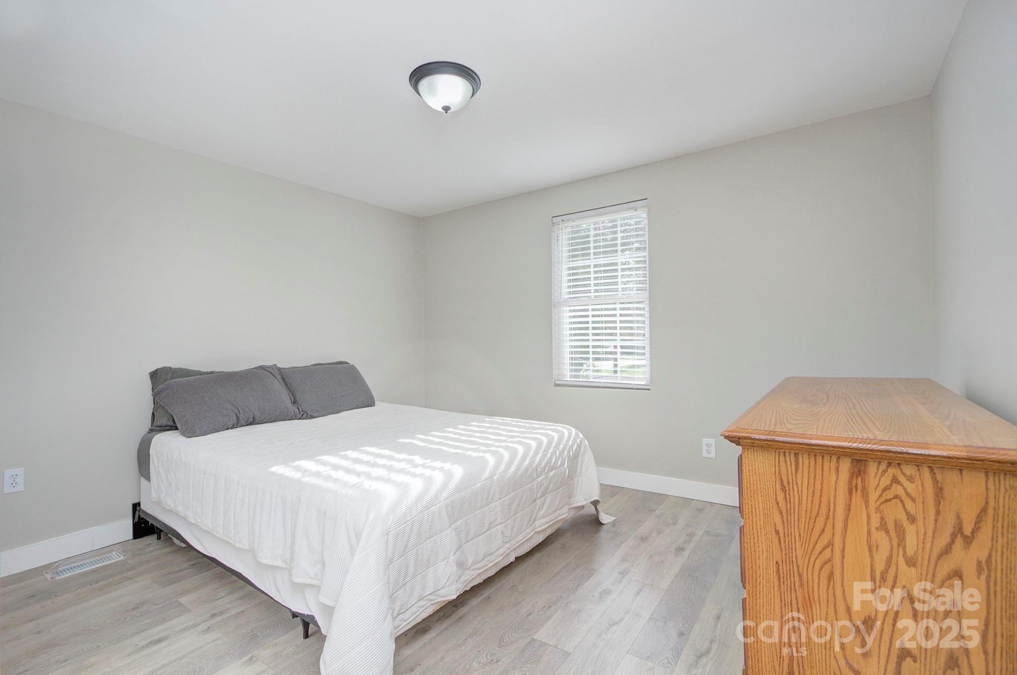 103 Moore Avenue Mount Holly, NC 28120 - Photo 11 of 21 a bedroom with a bed and a window