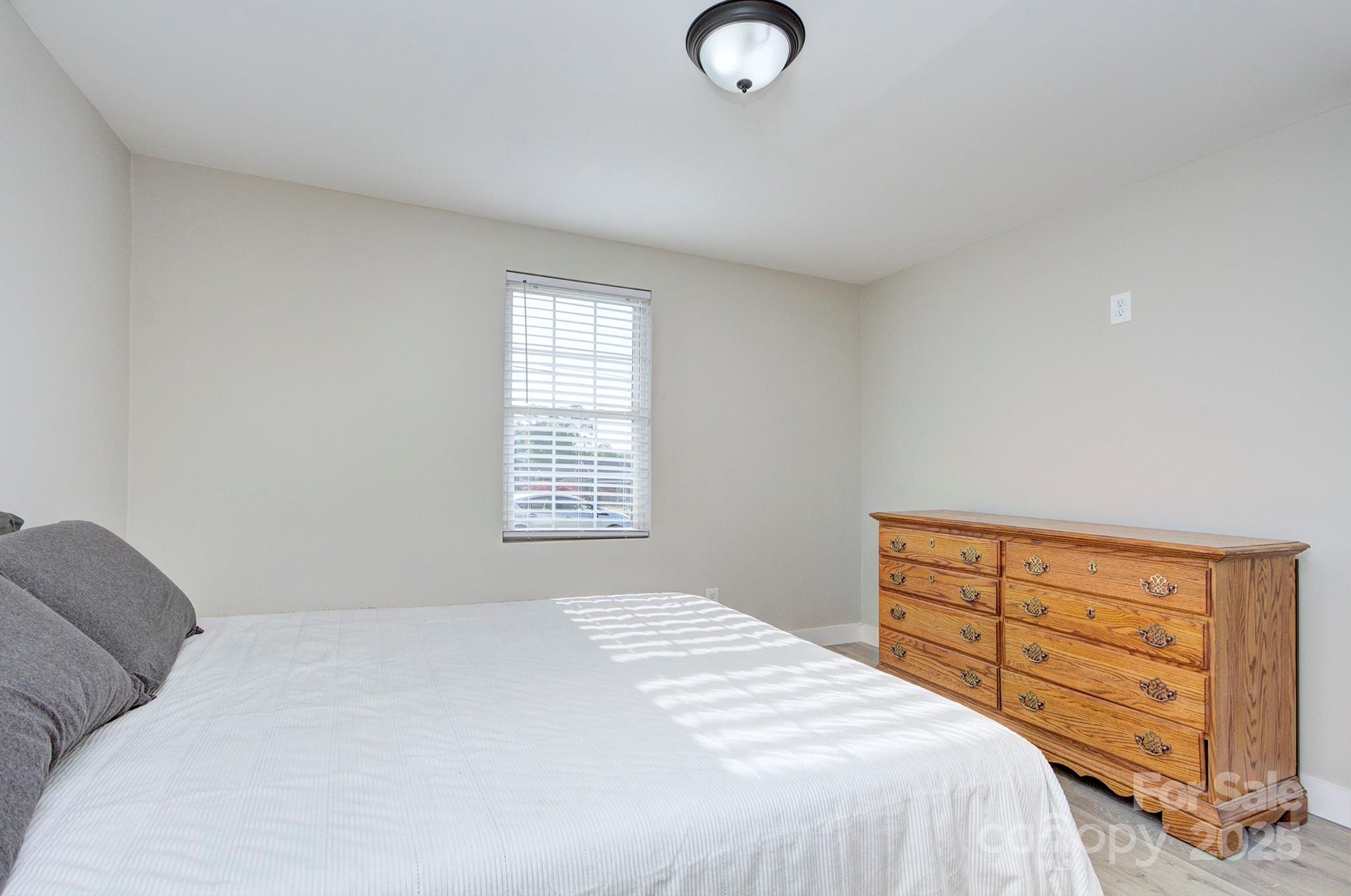 103 Moore Avenue Mount Holly, NC 28120 - Photo 13 of 21 a bedroom with a bed and a dresser