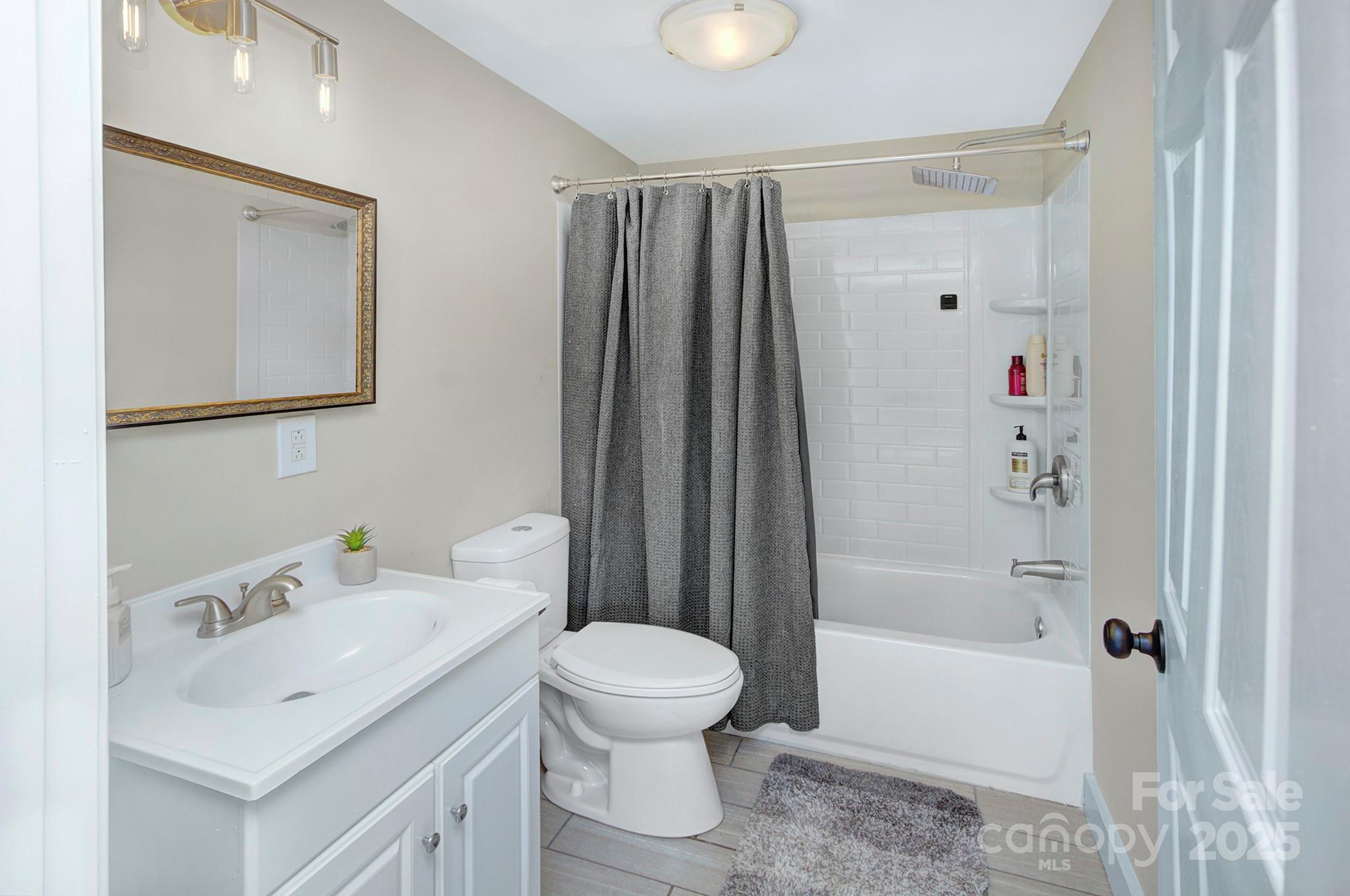 103 Moore Avenue Mount Holly, NC 28120 - Photo 14 of 21 a bathroom with a sink toilet and shower