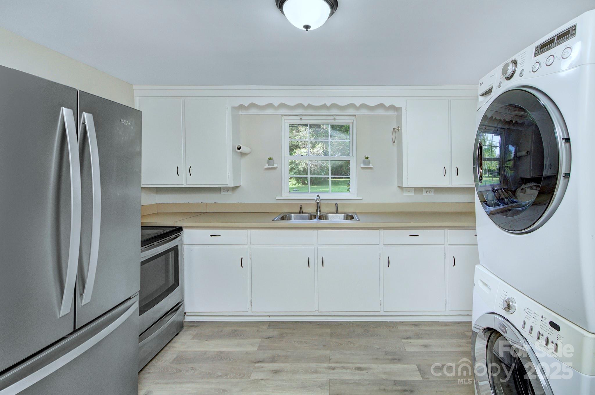 103 Moore Avenue Mount Holly, NC 28120 - Photo 9 of 21 a bathroom with a sink a washer and dryer