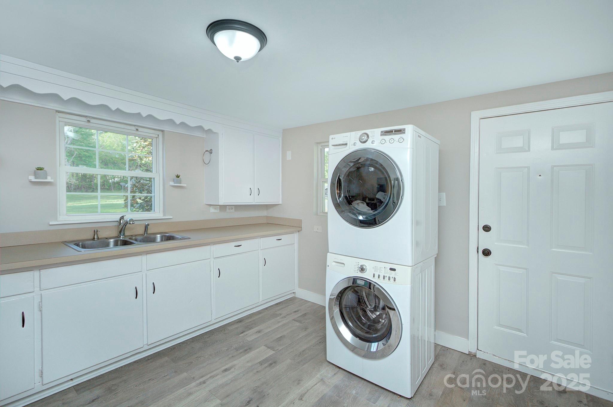 103 Moore Avenue Mount Holly, NC 28120 - Photo 10 of 21 a utility room with sink dryer and washer