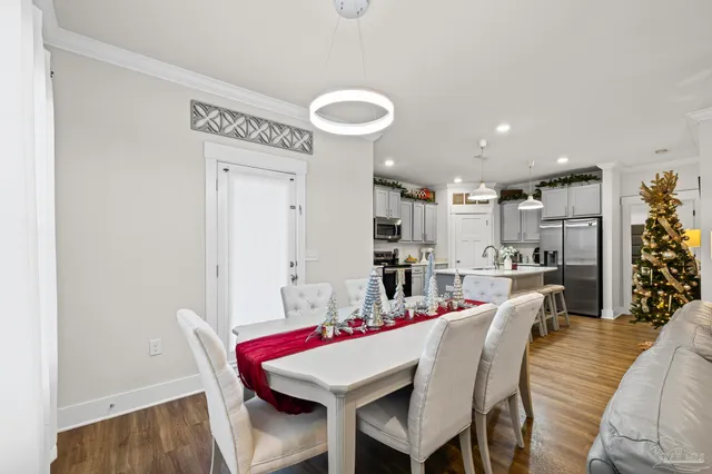 a view of a dining room with furniture and wooden floor
