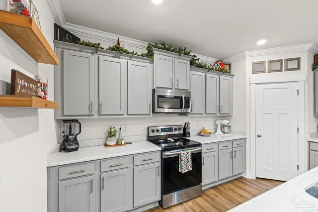 a kitchen with stainless steel appliances white cabinets and a sink