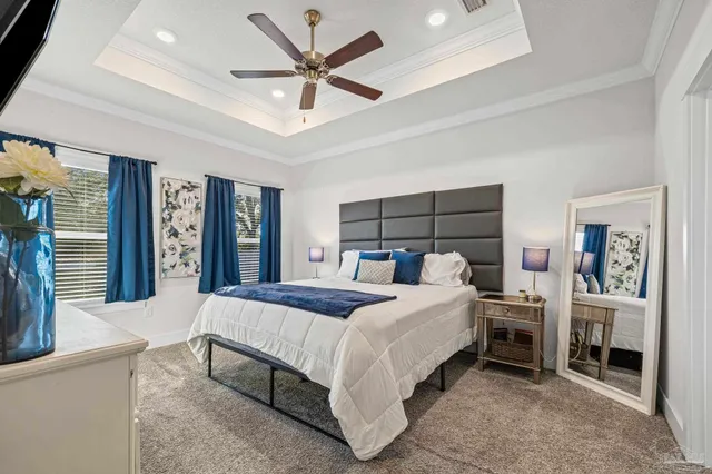 a bedroom with a large bed and a chandelier