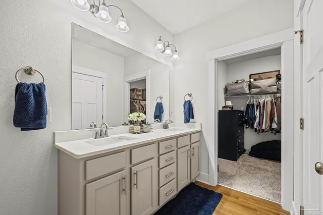 a bathroom with a sink a vanity and shower