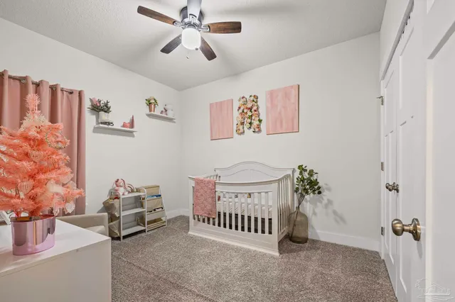a bedroom with furniture and a chandelier fan
