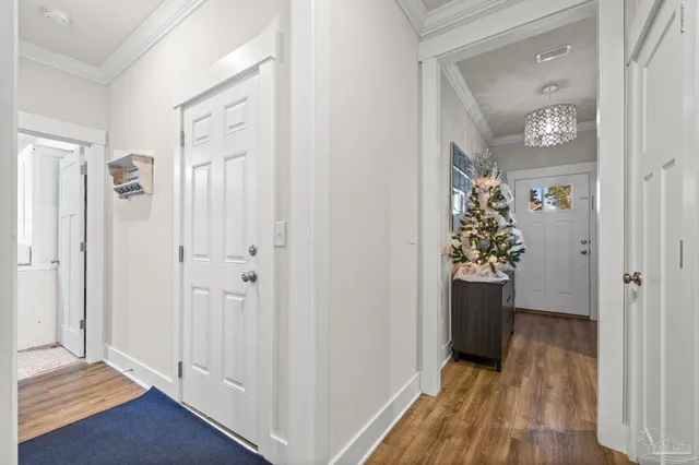 a view of a hallway with wooden floor and closet