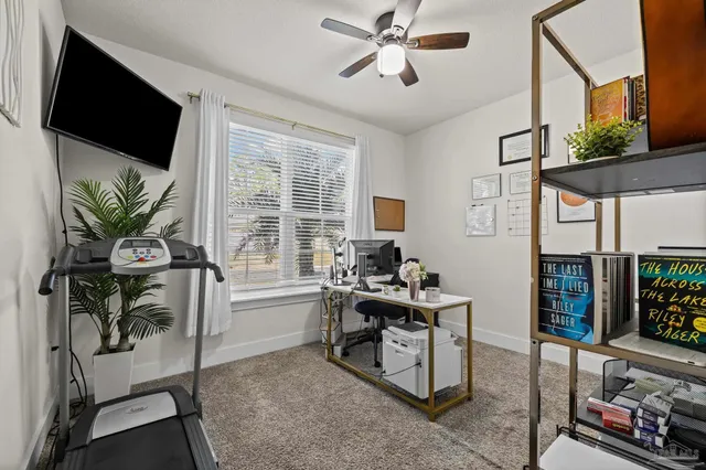 a work room with furniture and a flat screen tv