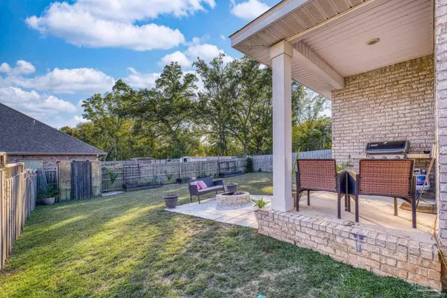 a view of a backyard with plants and a patio