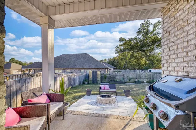 a view of a backyard with sitting area and furniture