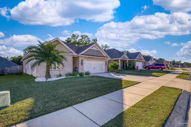a front view of house with yard and green space