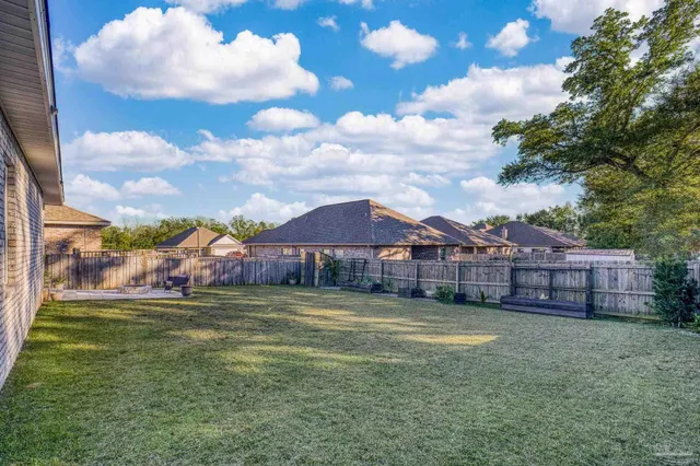 a view of a house with a big yard next to a yard