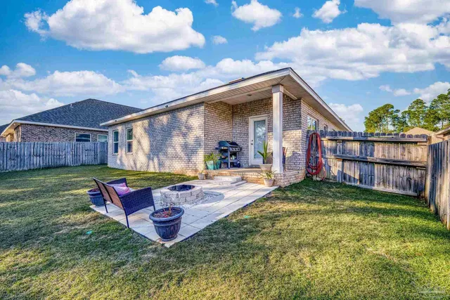 a view of an house with backyard space and porch