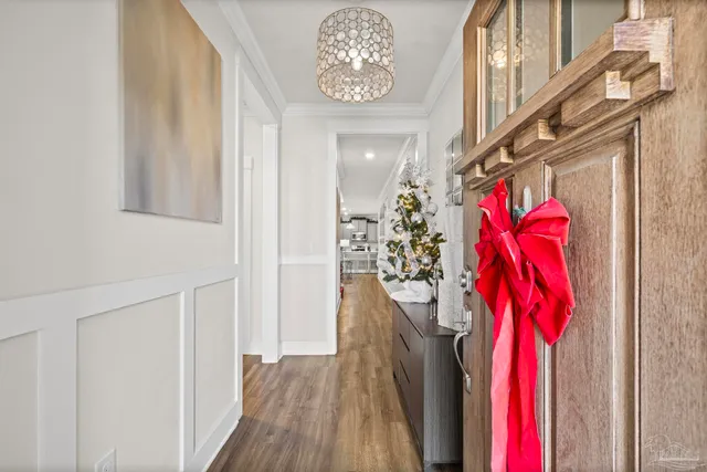 a view of a hallway with wooden floor and stairs