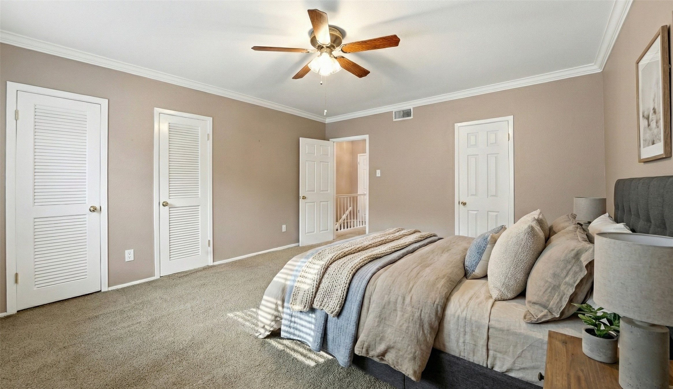 2232 South Piney Point Road, Unit 108 Houston, TX 77063 - Photo 13 of 32 a bedroom with a bed and a ceiling fan