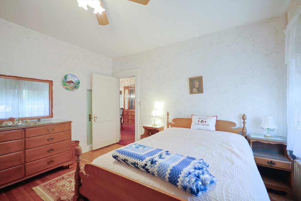 587 Common Street Walpole, MA 02081 - Photo 15 of 38 a bedroom with a bed and a dresser