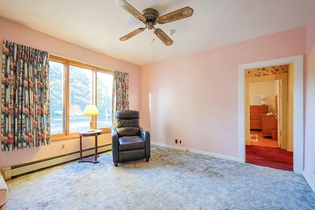 a living room with furniture and a floor to ceiling window