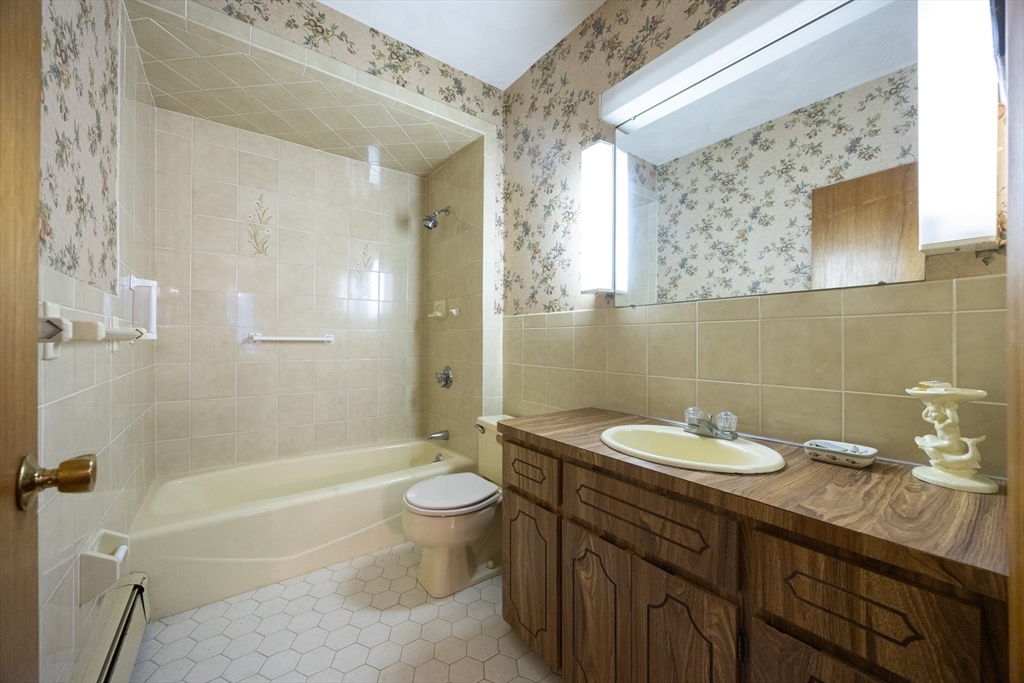 587 Common Street Walpole, MA 02081 - Photo 19 of 38 a bathroom with a sink a toilet and shower