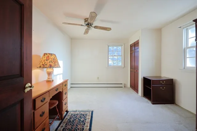 a view of workspace with window and wooden floor