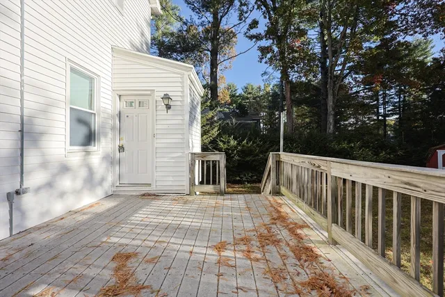 a view of a balcony with wooden floor and fence