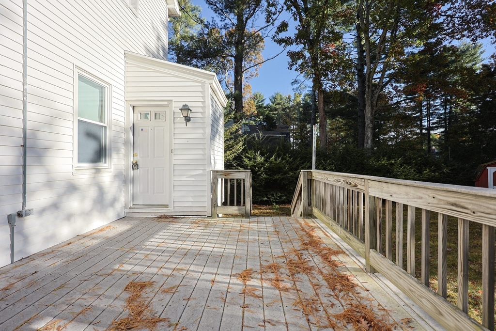 587 Common Street Walpole, MA 02081 - Photo 33 of 38 a view of a balcony with wooden floor and fence