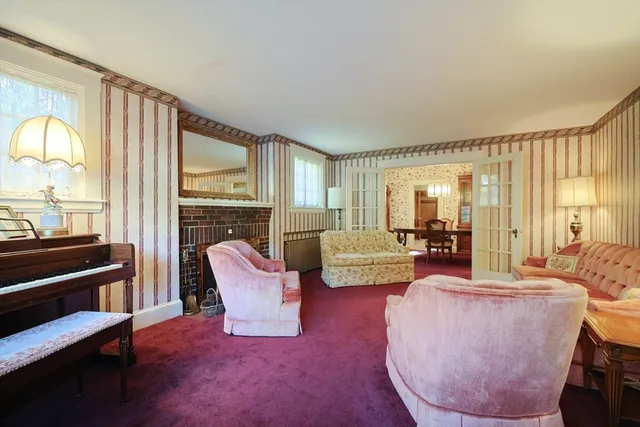 a living room with furniture fireplace and a table