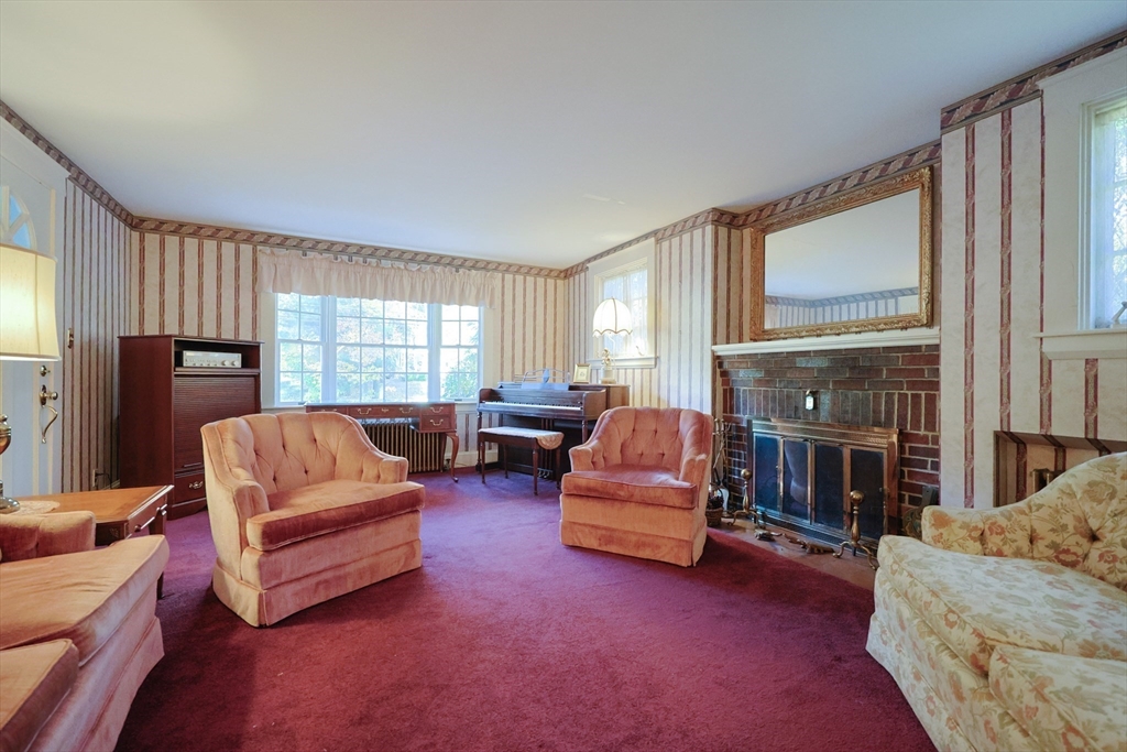 587 Common Street Walpole, MA 02081 - Photo 7 of 38 a living room with furniture fireplace and flat screen tv