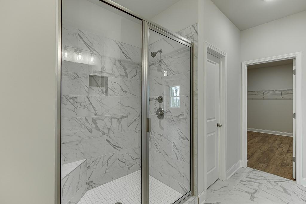 757 Woods Chapel Road Sugar Hill, GA 30518 - Photo 30 of 67 a bathroom with a shower and a sink