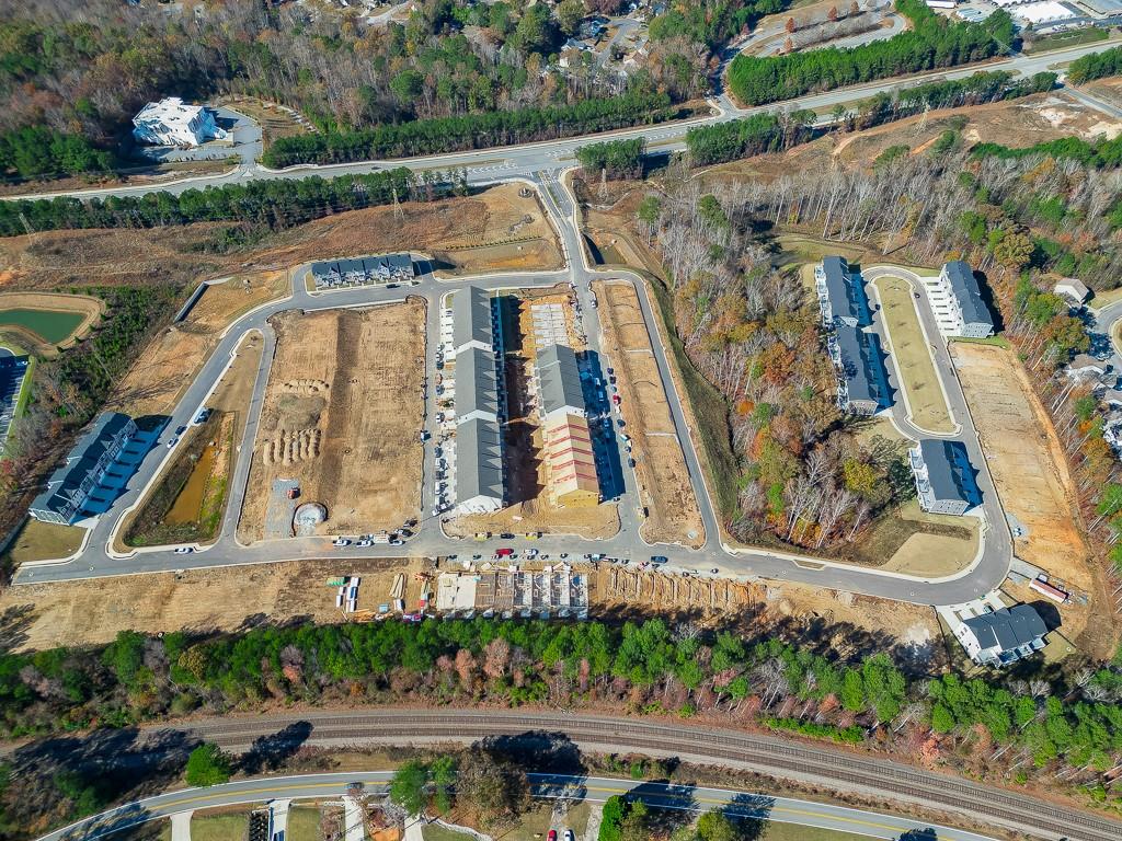 757 Woods Chapel Road Sugar Hill, GA 30518 - Photo 38 of 67 an aerial view of a house with a garden and statue