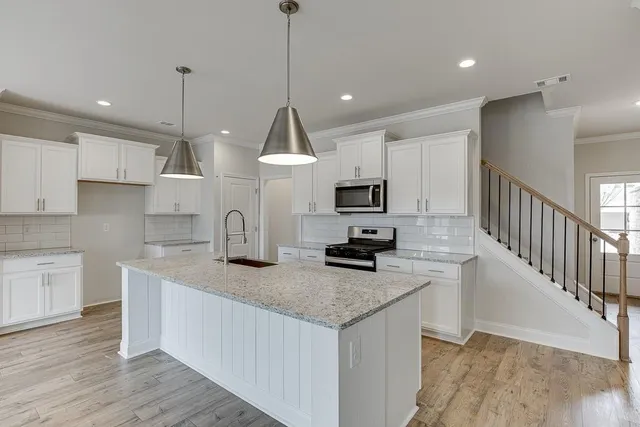 a large kitchen with stainless steel appliances kitchen island a large island in the center