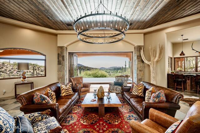 39601 North Ocotillo Ridge Drive Carefree, AZ 85377 - Photo 15 of 81 a living room with furniture a fireplace and a chandelier