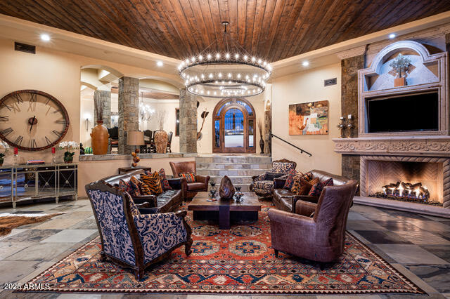 39601 North Ocotillo Ridge Drive Carefree, AZ 85377 - Photo 17 of 81 a living room with furniture a fireplace and a flat screen tv
